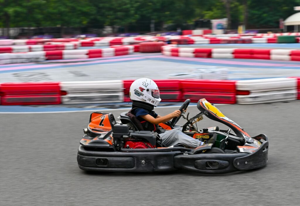 A kid go-karting in a racetrack